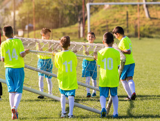 Young children players preparing for football match on soccer field