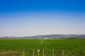 Fototapeta na wymiar airport runway and field with clear blue sky. Iasi, Romania