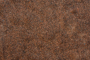Background image of the small brown, red and grey pebbles
