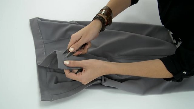 Removal of small threads left after sewing pants