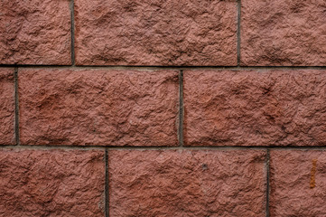 Red brick rustic wall textured background with a cement in a seams