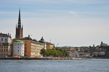 Fototapeta premium Cityscape view of Stockholm’s old town in famous Gamla Stan area densely situated by archaic buildings influenced by North German architecture
