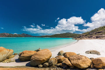 Rocks on amazing Whitehaven Beach with white sand in the Whitsunday Islands, Australia