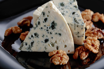 Wedges of soft blue cheese with walnuts.