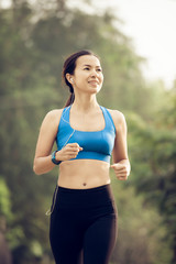 Fototapeta premium young sports woman runner running on road