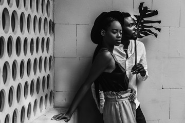 Lovely african newlyweds softly holding each other and smilling.