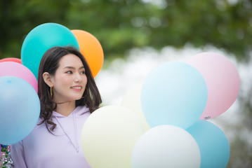 beautiful girl with balloons in park