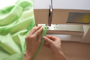 Sewing process close-up on the sewing machine. Industrial sewing machine in a private workshop at...