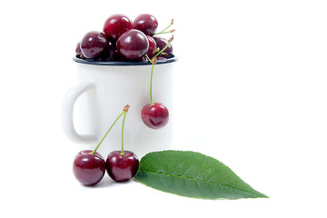 White cup with red sweet cherry isolated on a white background..