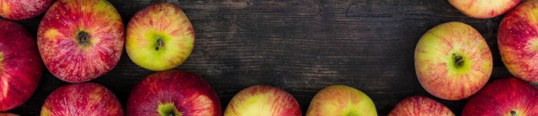 Banner of Apples on wooden table background. Fresh fruit backdrop with empty space for text