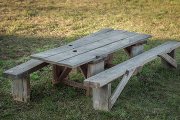 Vintage wooden table with benches in nature.