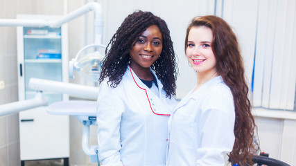 healthcare end health. Multiracial team of young doctors dentist in a hospital standing in a operating room. mixed race medical students school