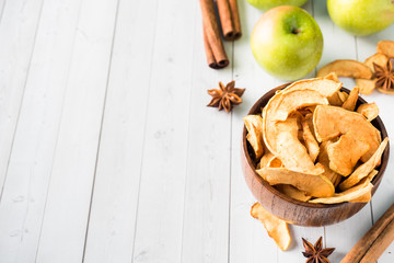Dried apples in a wooden bowl Ripe green apples on the table Copy space