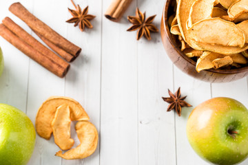 Dried apples in a wooden bowl Ripe green apples on the table Copy space