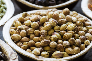 Dried indian coriander seeds in coconut bowl