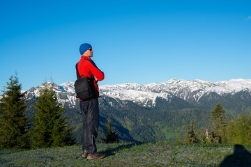 Fototapeta na wymiar Dreaming adventurer, photographer is standing on the mountain slope