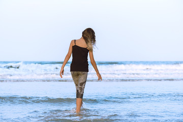Young girl on walking on the beach