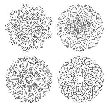 A set of black and white mandalas. Decorative round ornaments. Wicker design elements. Logos for yoga, backgrounds for posters, icons for programs and websites. The unusual shape of the flower. 