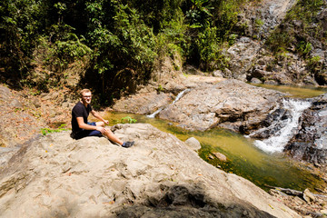 Naklejka na ściany i meble Tourist on Huai Sakae waterfall