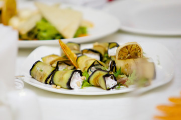 A dish of toppings, wrapped in fried eggplant.