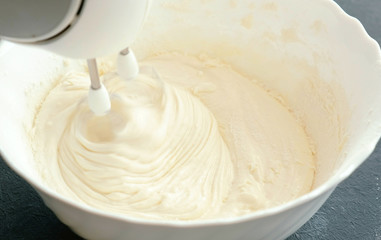 Close-up mixer whisk eggs with sugar in a bowl. Cooking apple pie.