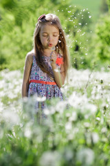Naklejka na ściany i meble dandelion field white girl beautiful happy little baby green meadow yellow flowers dandelions nature park garden