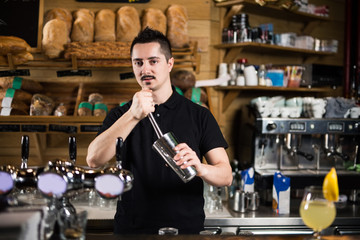 Male barista making cocktails