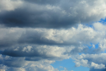 Background of gray dramatic clouds in a blue sky.