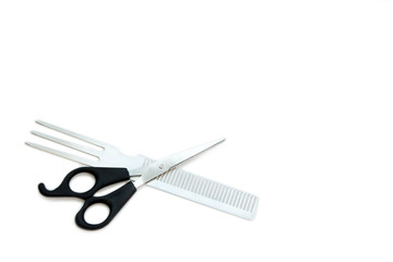 Hairdressing scissors with black handles and a metallic shiny comb on a white background. Close image.