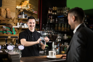 Male barista and caffe guest