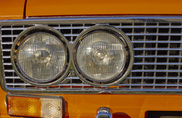 Orange old car headlight with space for text