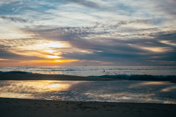 Naklejka na ściany i meble An amazing sunset on the coast at the ocean