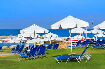 Sunbeds and umbrellas on public beach in Paphos, Cyprus