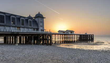 Fototapeta premium Sunrise at Penarth Pier. Penarth is a coastal town in South Wales, UK, near Cardiff the capital of Wales. The pier is a fine example of Victorian architecture