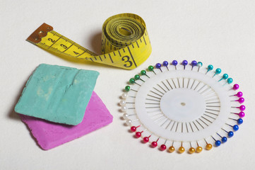 Tailoring tools and accessories, pins, measuring tape, marker.