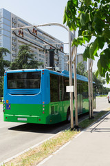 Naklejka premium Electric bus at a stop is charged by pantograph