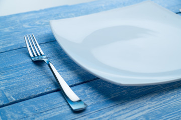 Plate and fork on a blue table