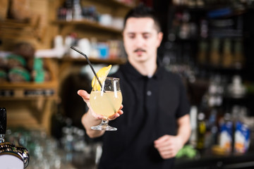Male barista making lemonade