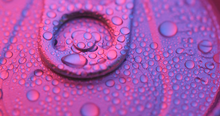 Aluminum beverage can under purple lighting