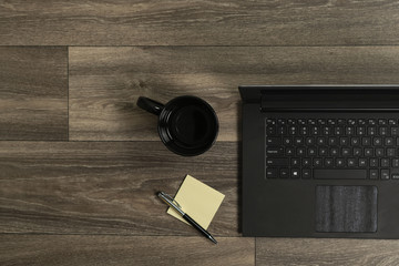 Laptop, mug notepad and pen