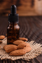 almond essential oil on a wooden background