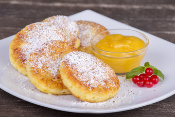 Delicious homemade cheese pancakes with raisin and honey