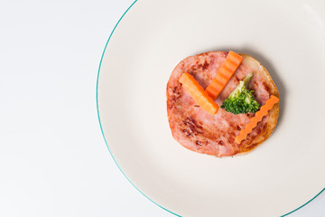 Grilled steak ham on white dish served with lettuce


