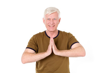 Welcome! Greeting. A happy middle-aged man shows his hands a greeting sign on Asian.