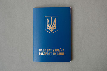 Foreign passport of Ukraine, is isolated on a gray background. Ukrainian traveler. Ukrainian emigrant. Visa-free regime for Ukraine