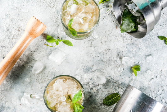 Cold summer beverage, mint julep cocktail drink, grey stone background copy space
