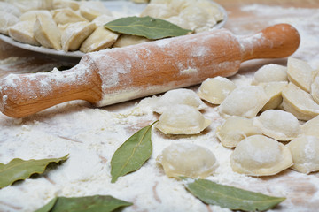 A bunch of dumplings with the Bay leaves and rolling-pin