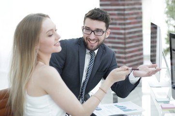 Senior manager and employee discussing financial documents