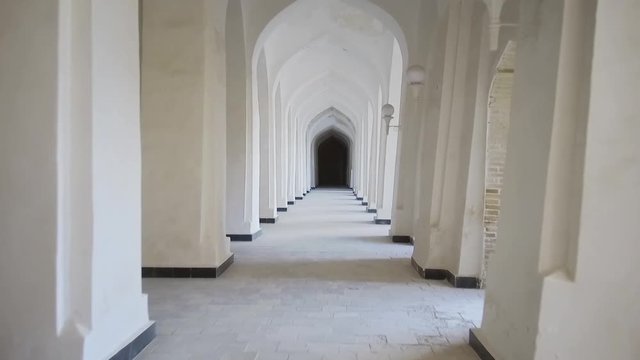 Arched hallway perspective at Mir-i-Arab medressa in Bukhara, Uzbekisan.