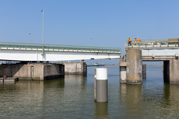 Construction workers repairing a bridge of Afsluitdijk near Kornwerderzand in the Netherlands.